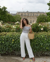 a lady wears an off shoulder striped slim top with white pants